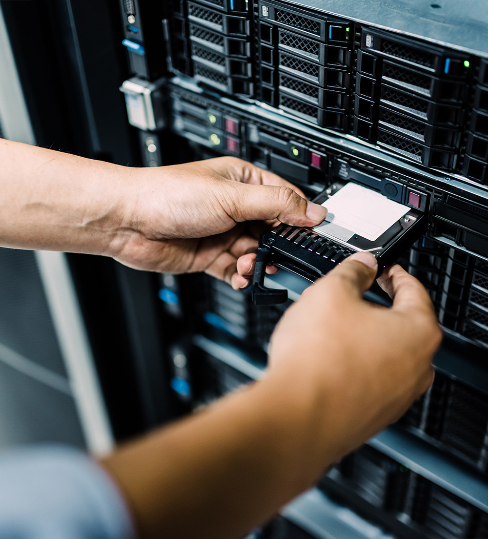 IT Manager entering a hard disk into the data center.