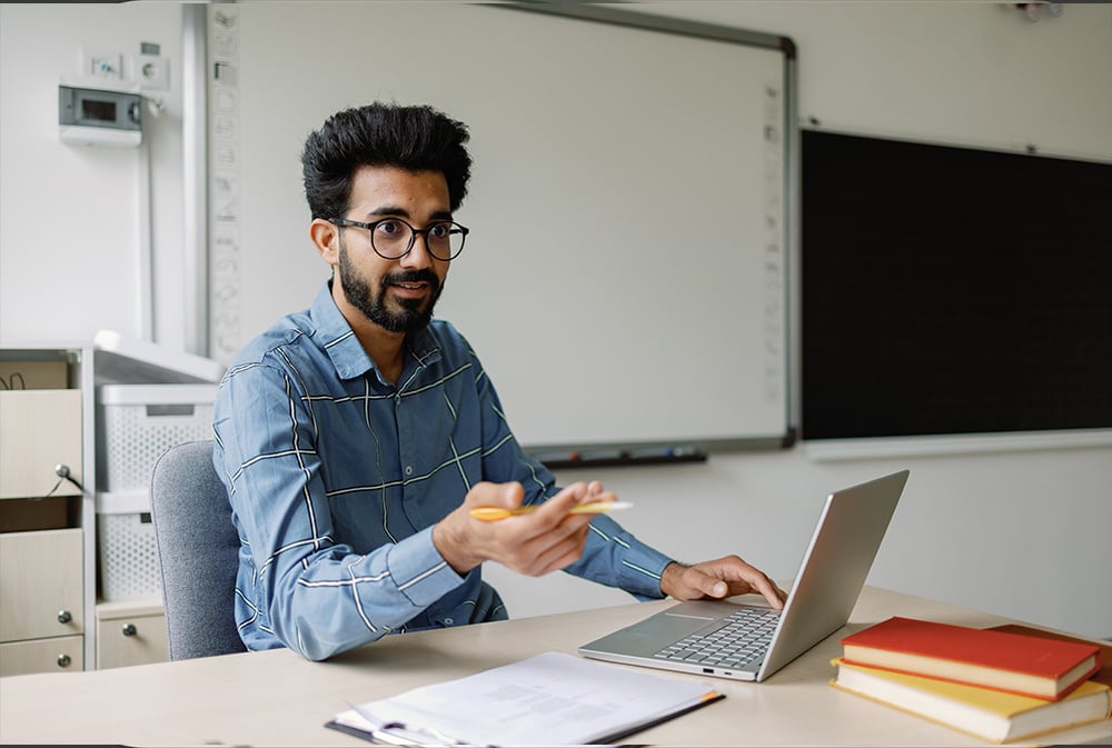 A man makes a presentation from his laptop.